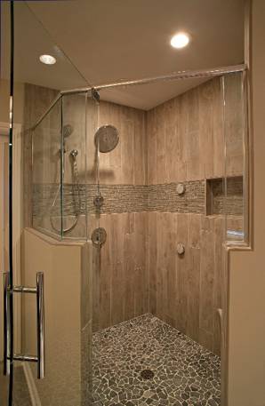 One of our favorite walk-in shower ideas is incorporating pebble floors to prevent slipping.